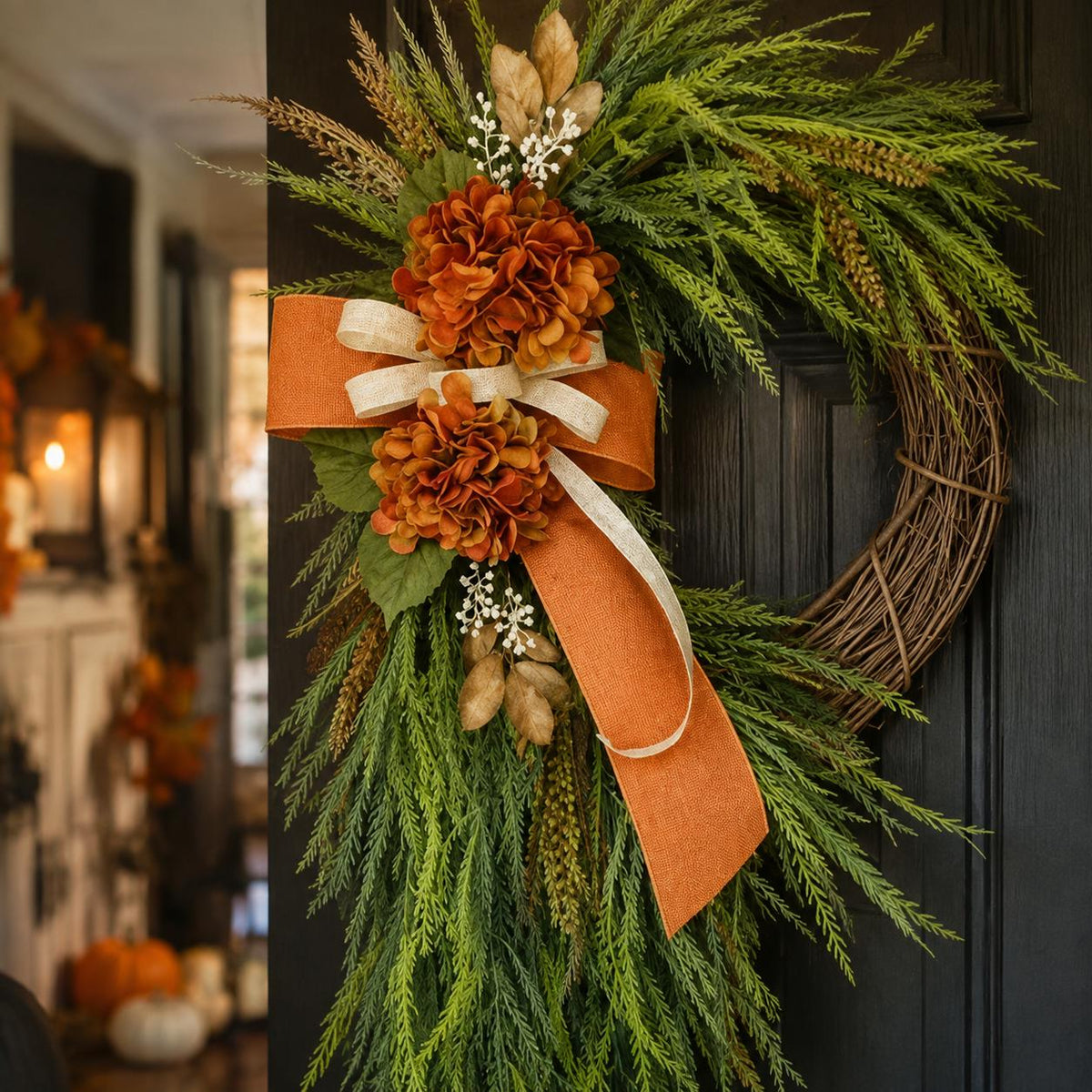 Close view of the burnt orange hydrangea clusters and layered rust and ivory ribbon bow